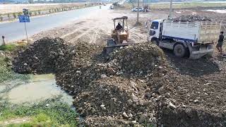 Excellent skill operator pushing dirt filling over puddle by Dozer Komatsu D31P and mini dump trucks [upl. by Wilmott]