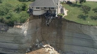 Couple looks on as house falls off cliff [upl. by Naryk]