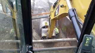 Cat 330d digging and laying 60quot concrete drain pipe [upl. by Darnall200]