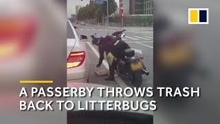 A passerby throws trash back into a litterbug’s car [upl. by Bogosian]