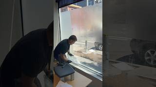 Process of removing old frosted window film in Seattle downtown windowfilm commercialwindowtint [upl. by Annauqal]