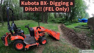 Kubota BX Digging a ditch with the front end loader [upl. by Nyllewell]