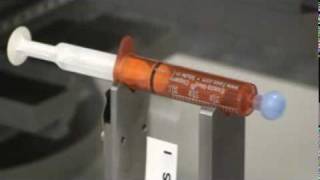 SemiAutomatic Labeling System applying labels to syringes [upl. by Revorg586]